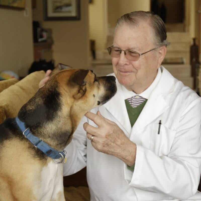Dr. Bill examining dog